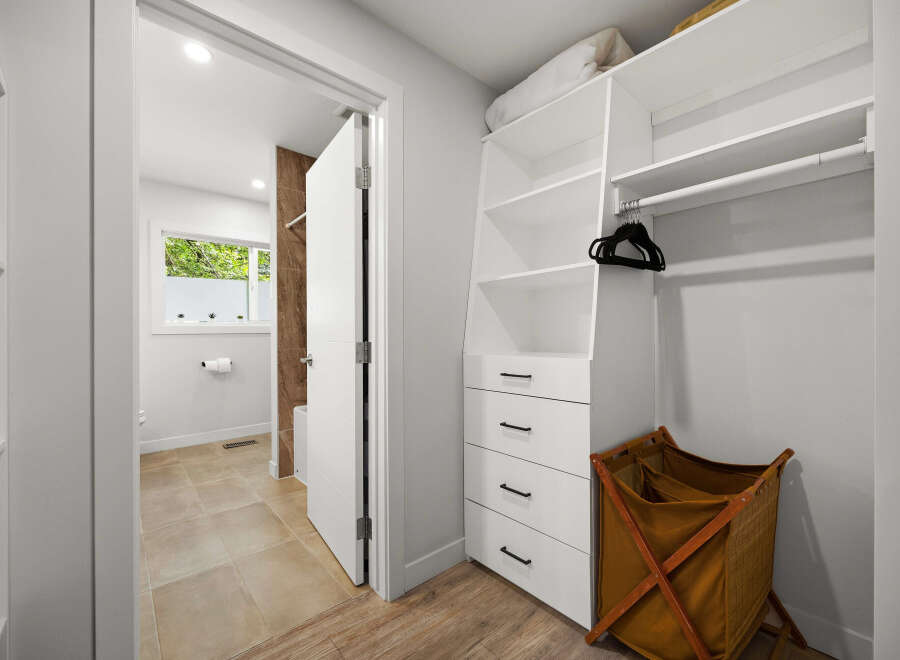 Discover this beautifully organized closet featuring ample shelving and drawers for all your storage needs.