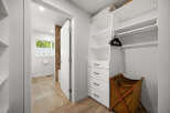 Discover this beautifully organized closet featuring ample shelving and drawers for all your storage needs.