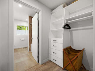 Discover this beautifully organized closet featuring ample shelving and drawers for all your storage needs.