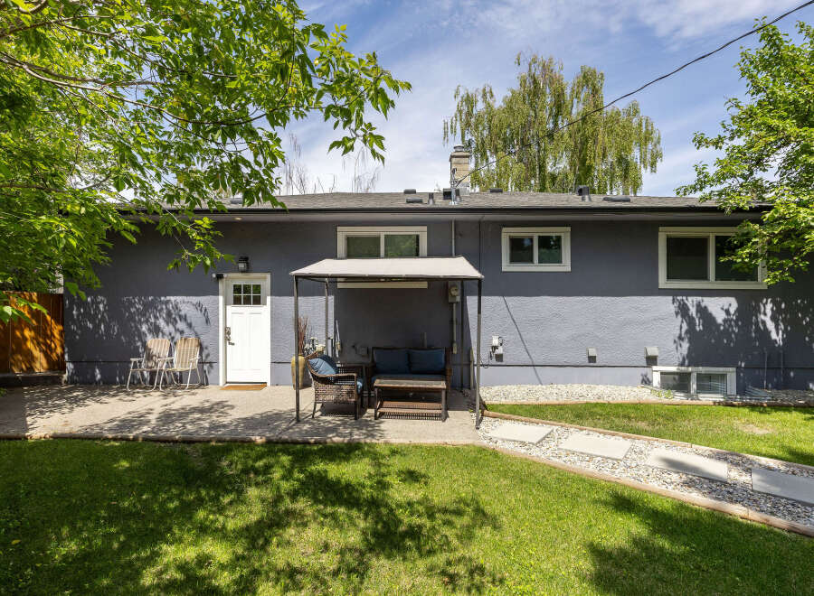 Enjoy outdoor living in this charming backyard featuring a spacious patio perfect for entertaining.