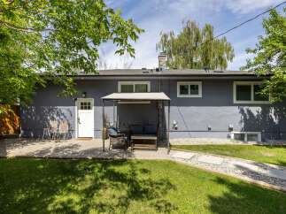 Enjoy outdoor living in this charming backyard featuring a spacious patio perfect for entertaining.