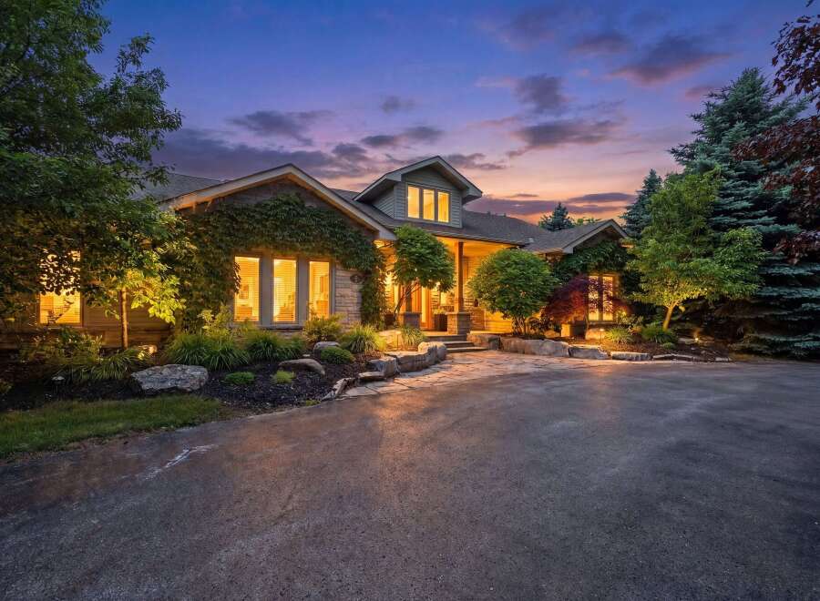 Experience luxury living in this stunning home, beautifully illuminated at dusk.