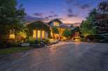 Experience luxury living in this stunning home, beautifully illuminated at dusk.