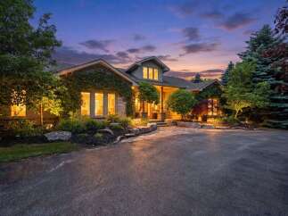 Experience luxury living in this stunning home, beautifully illuminated at dusk.