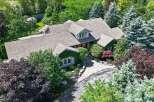 Discover this stunning property featuring a beautifully landscaped yard with mature trees and lush greenery.