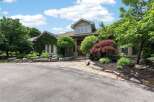 Discover this stunning home featuring a natural stone facade and lush landscaping, creating an inviting curb appeal.