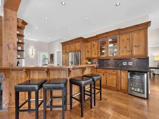 This spacious kitchen boasts a stunning wooden bar area, perfect for entertaining guests.