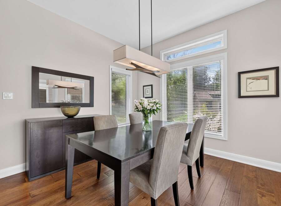 This elegant dining room features a dark wood dining table with upholstered chairs, perfect for hosting family and friends.