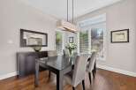 This elegant dining room features a dark wood dining table with upholstered chairs, perfect for hosting family and friends.