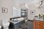 Indulge in luxury in this stunning bathroom featuring a deep soaking tub and a separate glass-enclosed shower.
