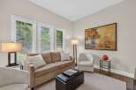 This inviting living room features a plush tan sofa adorned with white throw pillows, perfect for relaxation.