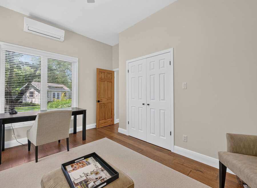 This bright and airy room features a modern desk and chair setup, perfect for a home office or study space.