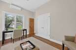 This bright and airy room features a modern desk and chair setup, perfect for a home office or study space.