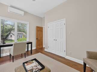 This bright and airy room features a modern desk and chair setup, perfect for a home office or study space.