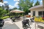 Enjoy outdoor living at its finest on this expansive deck, featuring a covered dining area, a luxurious hot tub, and comfortable seating.