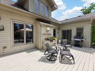 Enjoy outdoor living on this spacious deck, perfect for entertaining or relaxing.