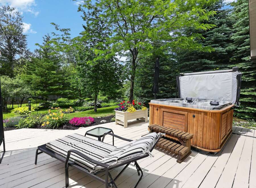 Enjoy ultimate relaxation in this backyard oasis featuring a luxurious hot tub perfect for unwinding.