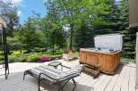 Enjoy ultimate relaxation in this backyard oasis featuring a luxurious hot tub perfect for unwinding.
