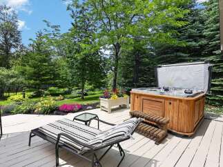 Enjoy ultimate relaxation in this backyard oasis featuring a luxurious hot tub perfect for unwinding.