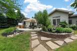 Enjoy outdoor living with this spacious deck featuring a covered seating area and a hot tub, perfect for relaxation and entertaining.