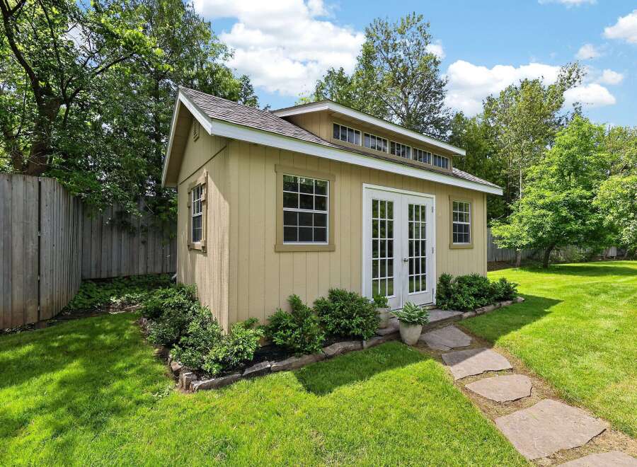 Discover this charming backyard shed, perfect for storage or as a creative studio space.
