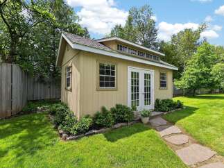 Discover this charming backyard shed, perfect for storage or as a creative studio space.