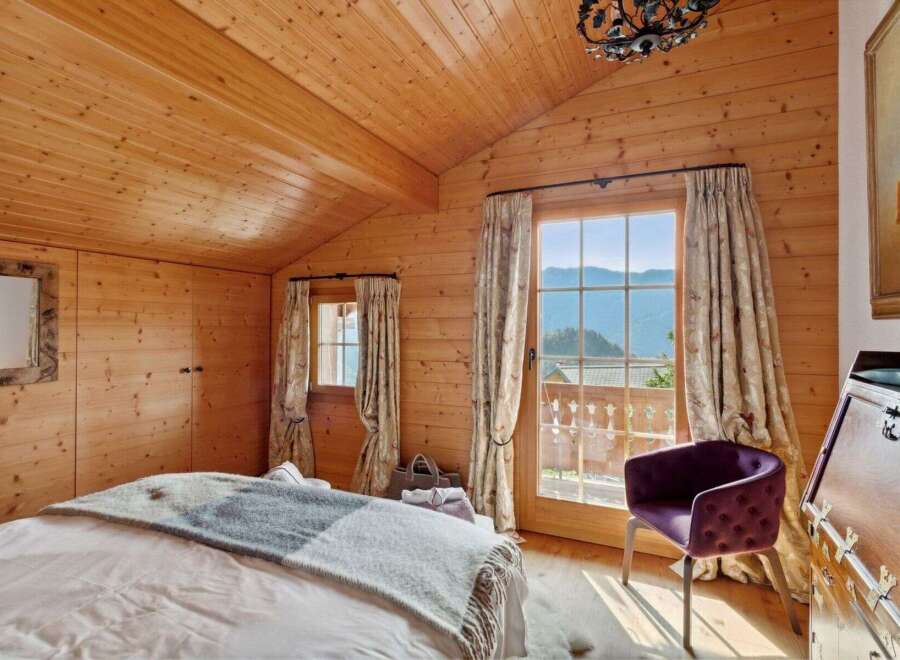 Experience rustic charm and breathtaking mountain views from this cozy bedroom.