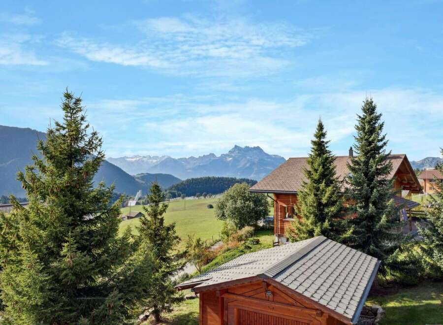 Experience serene mountain living in this charming wooden chalet, nestled amidst lush greenery and offering breathtaking views of snow-capped peaks.