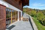 Enjoy breathtaking mountain views from this charming chalet's spacious patio, perfect for al fresco dining or relaxing with a book.