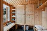 This charming entryway features a built-in wooden wardrobe and shelving, perfect for organizing outerwear and accessories.