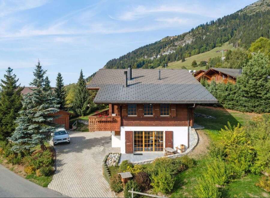 Experience alpine living in this charming wooden chalet, nestled amidst lush greenery and rolling hills.