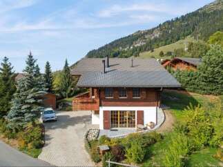 Experience alpine living in this charming wooden chalet, nestled amidst lush greenery and rolling hills.