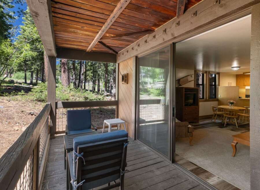 Enjoy the serene mountain setting from this charming cabin's private deck, perfect for morning coffee or evening relaxation amidst the tall pines.