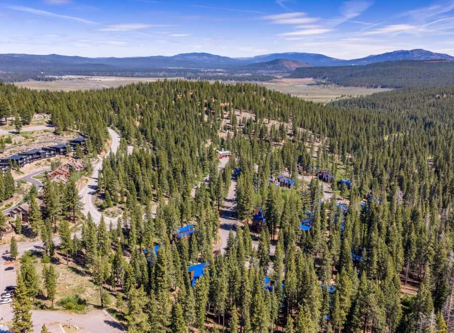 Discover this stunning mountain retreat nestled amidst a dense forest of evergreen trees.