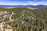 Discover this stunning mountain retreat nestled amidst a dense forest of evergreen trees.