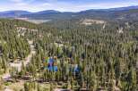 Nestled amidst a dense forest of tall pine trees, this property offers a serene mountain retreat.