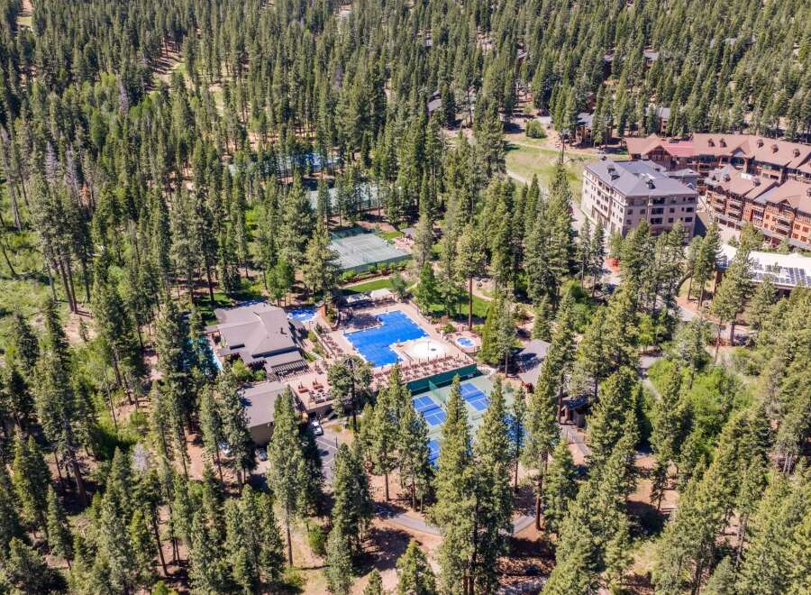 Discover this stunning resort-style property nestled amidst a dense pine forest.