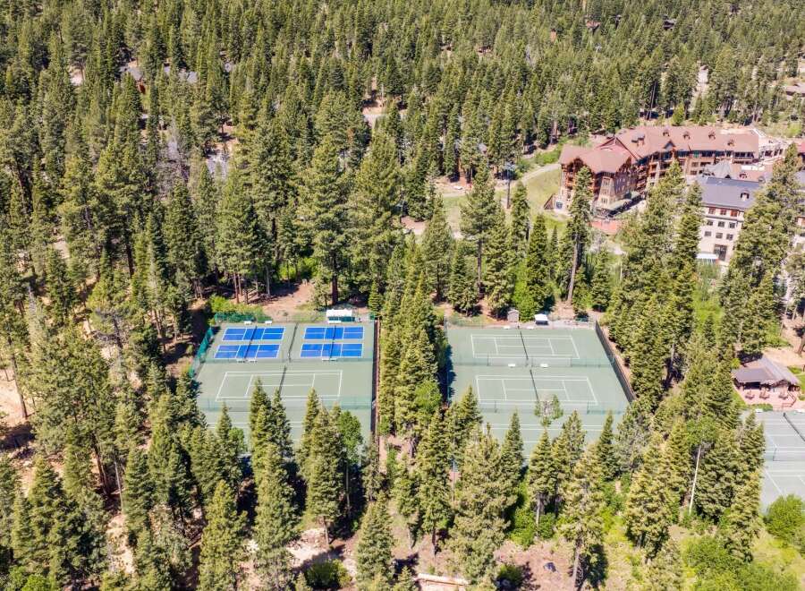 Experience luxury living with access to pristine tennis courts nestled amidst a lush pine forest.
