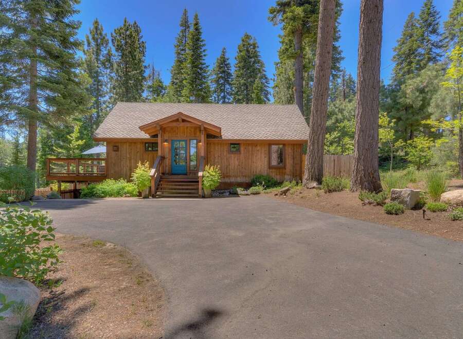 Nestled among tall pine trees, this charming wooden cabin offers a serene retreat.