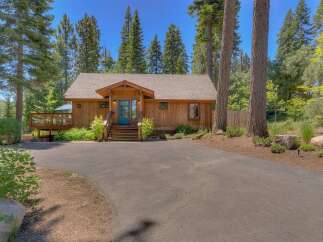Nestled among tall pine trees, this charming wooden cabin offers a serene retreat.
