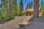 Nestled amidst towering pine trees, this charming wooden cabin offers a serene mountain retreat.