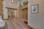 Step into a charming entryway featuring rustic sliding barn doors that lead to a saloon-style bar area.