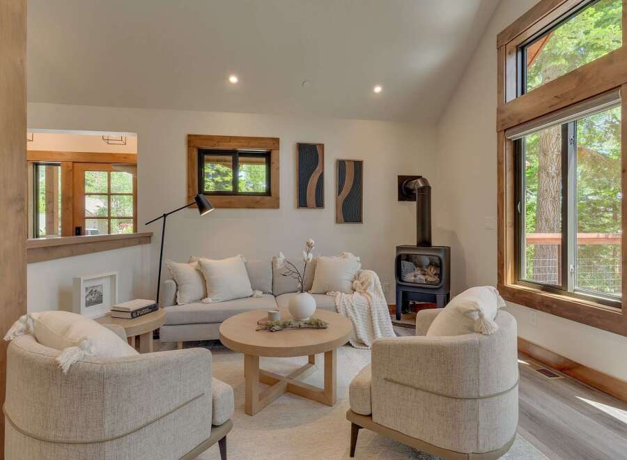 Experience cozy living in this inviting living room, featuring a modern wood-burning stove perfect for chilly evenings.