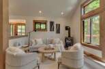 Experience cozy living in this inviting living room, featuring a modern wood-burning stove perfect for chilly evenings.