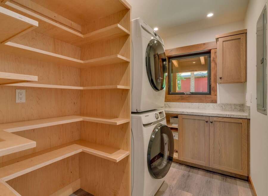 Discover the ultimate in laundry convenience with this stacked Samsung washer and dryer set, perfectly integrated into a stylish and functional laundry room.