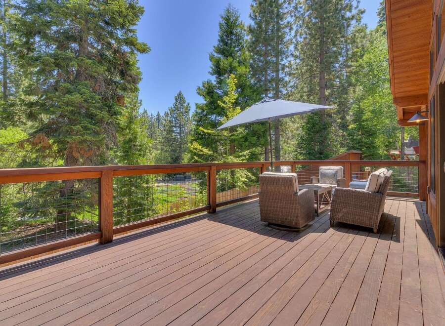 Enjoy the serene mountain lifestyle from this expansive wooden deck, perfect for outdoor entertaining or quiet relaxation.