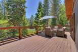 Enjoy the serene mountain lifestyle from this expansive wooden deck, perfect for outdoor entertaining or quiet relaxation.