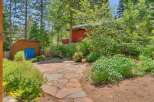 Discover this charming backyard oasis featuring a rustic flagstone patio perfect for outdoor entertaining.