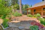 Discover this charming backyard oasis featuring a natural stone patio perfect for outdoor entertaining.