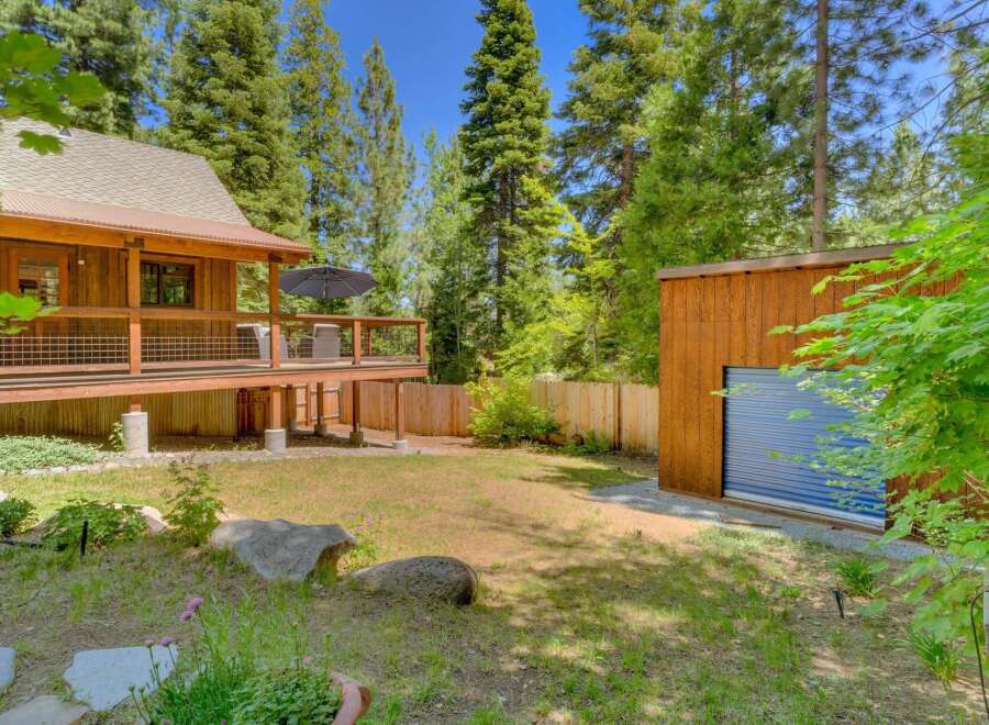 Experience rustic charm with this wooden cabin featuring a spacious deck perfect for outdoor relaxation.